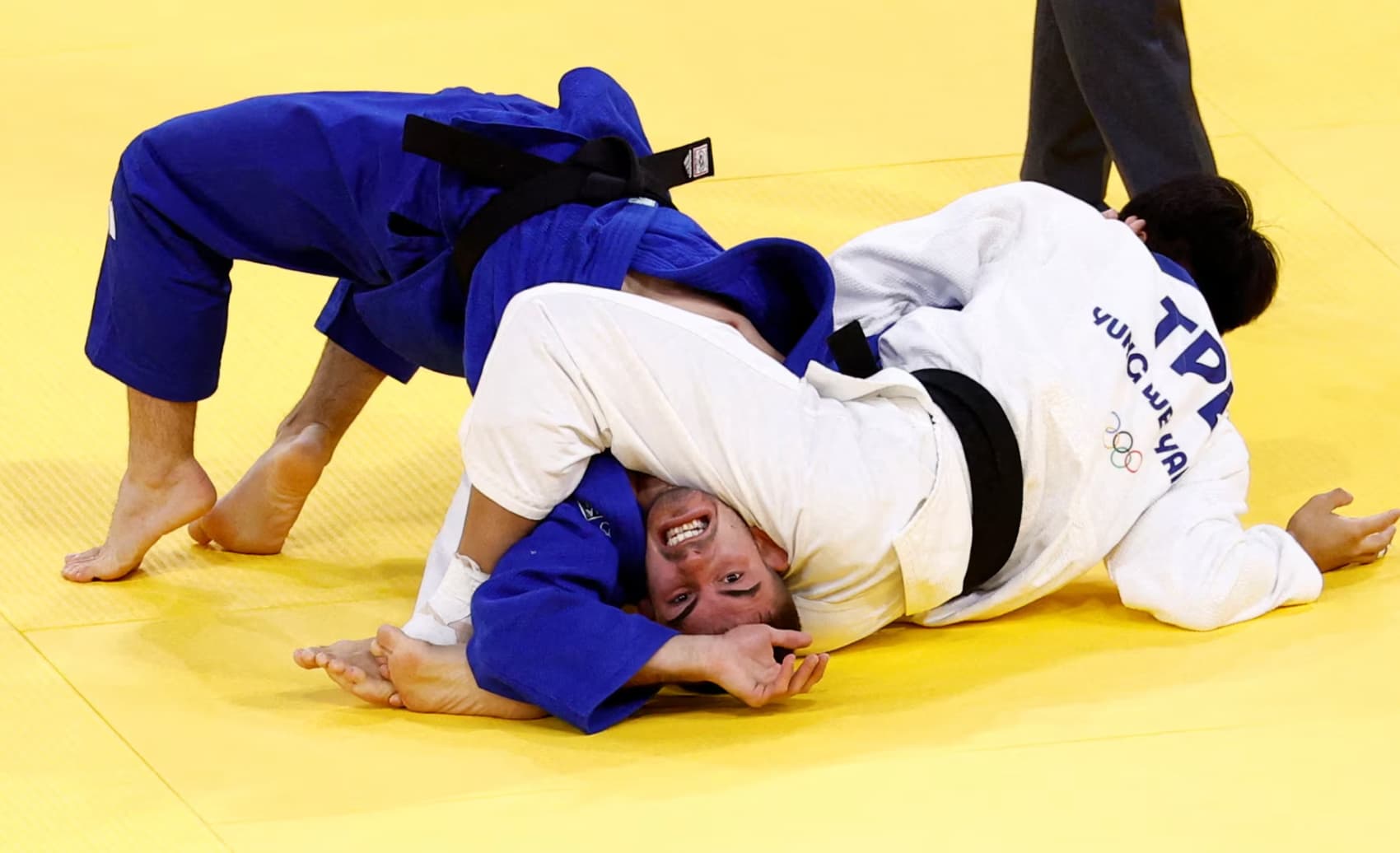 Chinese Taipei’s Yung Wei Yang grapples with Italy’s Carlino Andrea during a judo elimination round. 